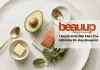 Minimalist editorial flat lay of keto diet staples: avocado, wild salmon, leafy greens, and grass-fed butter.