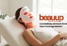 Editorial photo of relaxed woman wearing glowing red light currentbody led mask in luxury home setting.