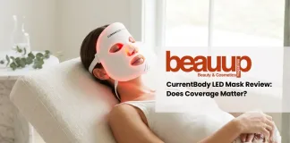 Editorial photo of relaxed woman wearing glowing red light currentbody led mask in luxury home setting.
