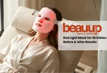 Woman wearing an LED face mask for wrinkles with a soft red glow in a luxury minimalist setting.
