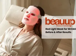 Woman wearing an LED face mask for wrinkles with a soft red glow in a luxury minimalist setting.