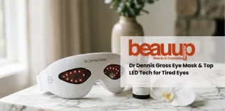 Dr. Dennis Gross SpectraLite LED eye mask on luxury white marble surface.